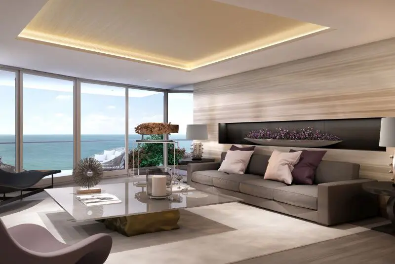 Vivienda moderna con vistas al mar, amplio salón decorado con estilo elegante, grandes ventanales y mobiliario sofisticado, perfecta para quienes buscan lujo y confort en propiedades en venta o alquiler en la costa.