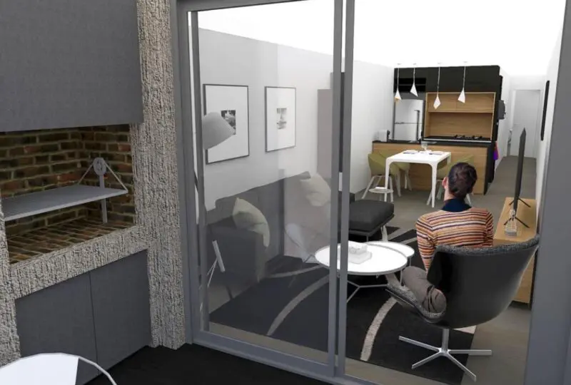 Amplia vista del interior de una vivienda moderna con sala de estar, cocina equipada y un espacio de trabajo, ideal para comprar o alquilar propiedades con la asesoría de Horus Real Estate Agency en Madrid.