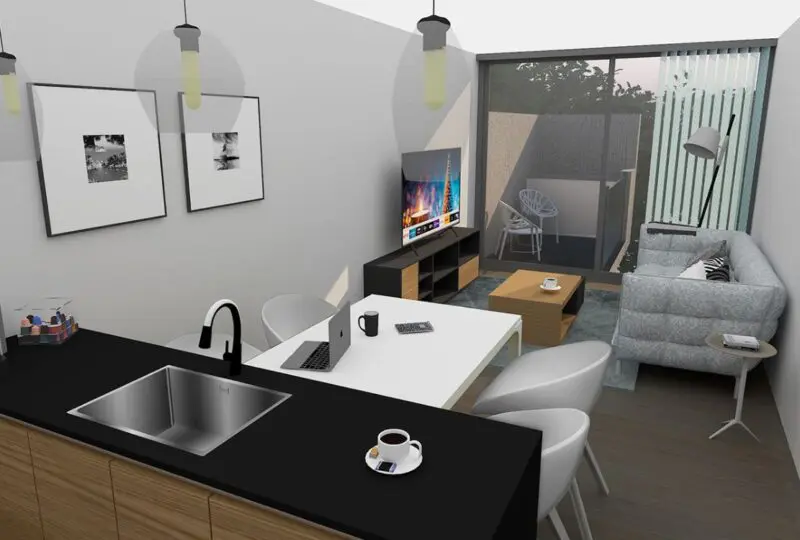 Amplia vista de un apartamento moderno con cocina abierta, zona de estar con sofá gris, televisión y balcón con vistas exteriores, ideal para inversión inmobiliaria en Horus Real Estate Agency.