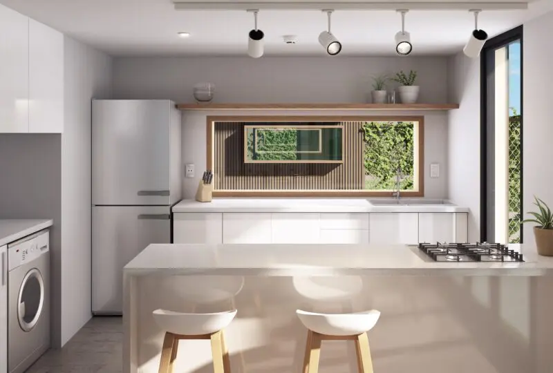 Lavabo moderno en cocina con iluminación empotrada y vista a jardín en propiedad residencial.