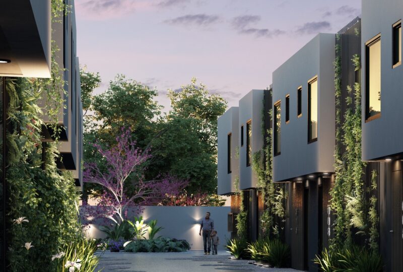 Moderno complejo de viviendas con diseño arquitectónico contemporáneo, áreas verdes y zona peatonal, ideal para vida familiar y inversión en bienes raíces en una zona exclusiva.